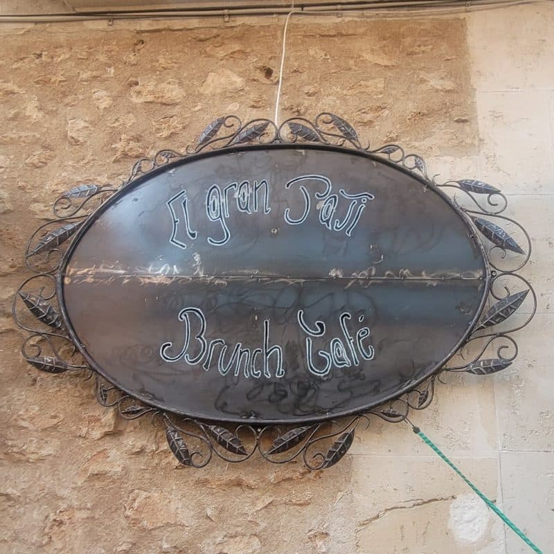 The oval iron sign reading El Gran Pati, Brunch Café